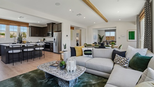Spacious open-concept great room and dining room with vaulted ceiling