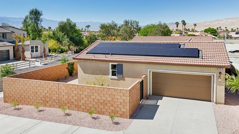 Aerial photo of single story home with solar panels