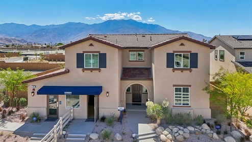 Two-story Spanish home with shutters