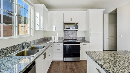 Kitchen with granite countertops and white cabinets