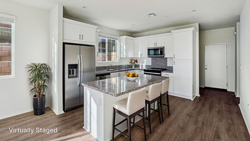 Kitchen with granite countertops and white cabinets