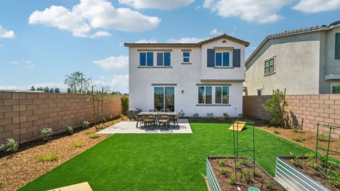 Spacious backyard with patio area and outdoor furniture