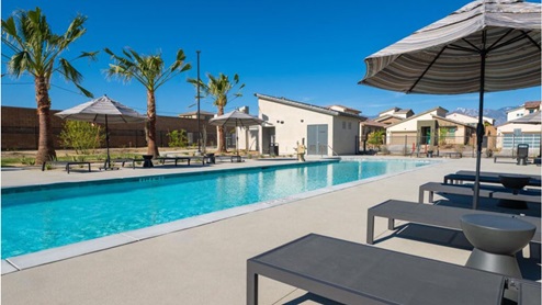 Community pool with lounge chairs
