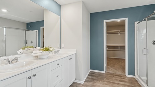 Primary bathroom with white cabinets