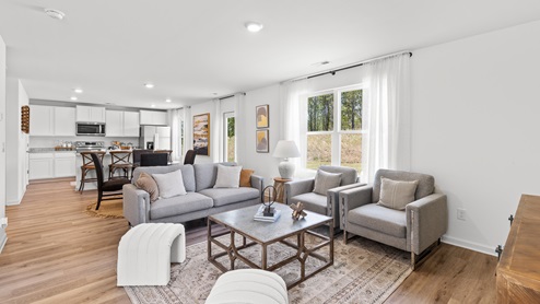 Penwell – Living Room – 1 - A well-designed living room with elegant hardwood floors and an open kitchen.