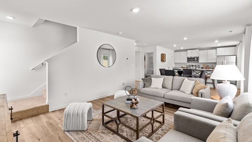 Penwell – Living Room – 1 - A well-designed living room with elegant hardwood floors and an open kitchen.