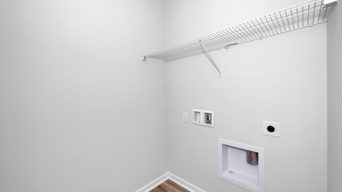 Laundry room with wire shelf and washer dryer hook up