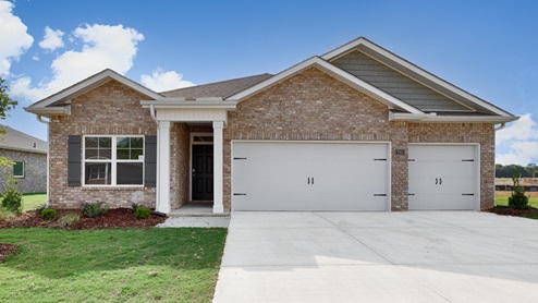 Single story home with brick and three car garage