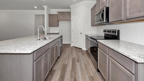 Kitchen island with stained cabinets and stainless steel appliances