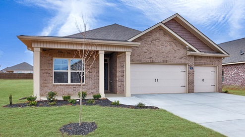 Single story home with brick and three car garage