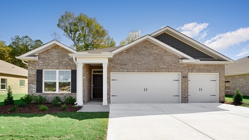 Single story home with brick and three car garage