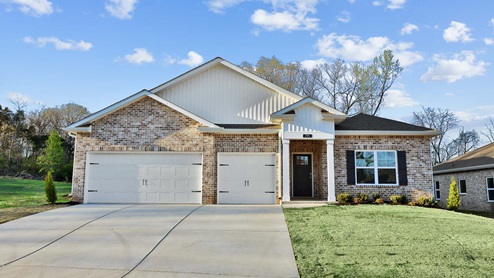 Single story home with hardi and brick and three car garage