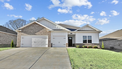 Single story home with hardi and brick and three car garage