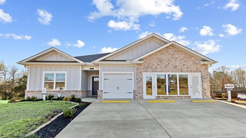 Single story home with hardi and brick and three car garage