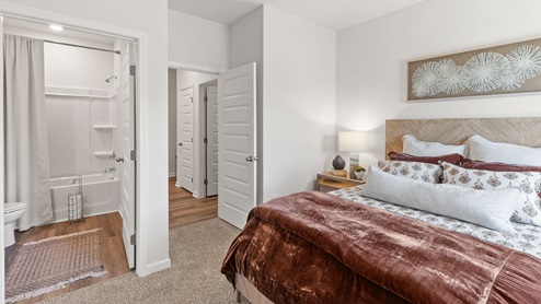 Secondary bedroom with carpet and window