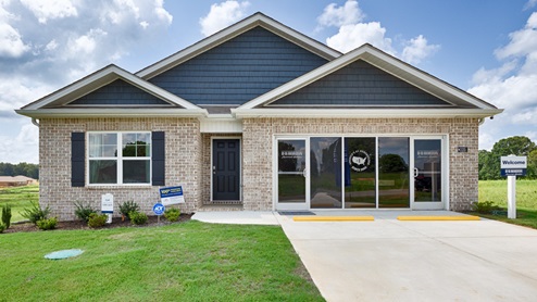 Single story home with brick, covered porch and two car garage
