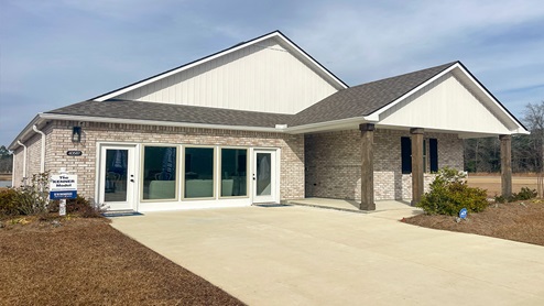 single-story home with tan brick and tan siding with porch