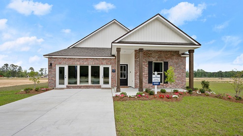 single-story home with red brick and tan siding with large porch and open store front