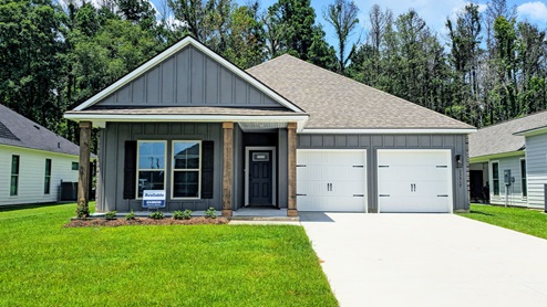 single-story home with gray brick and gray siding and patio and two-car garage