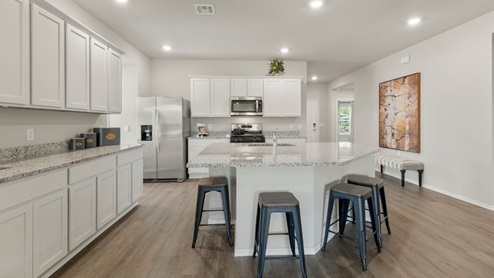 kitchen with massive island and painted cabinets