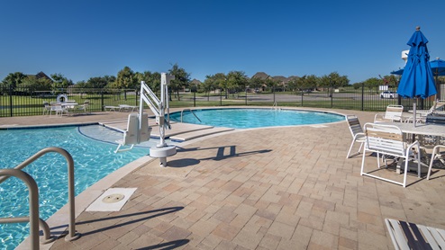 Williamsburg large swimming pool with lush landscapes
