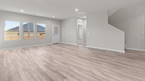 Open concept living space with upstairs access to the side