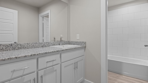 Attached primary bathroom with water closet and bathtub space
