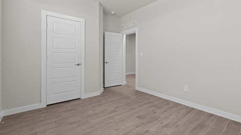 Guest bedroom 1 with front windows and ample natural light
