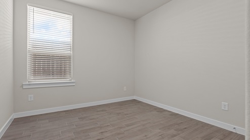 Guest bedroom 2 with side window and plush carpet floor