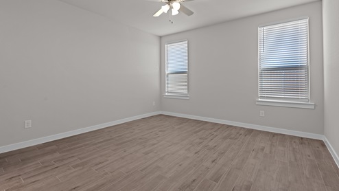 Primary bedroom with plush carpet floors and light allowing double windows