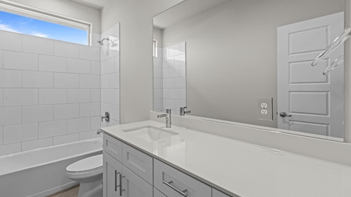 Guest bathroom with built in vanity and combination bathtub shower