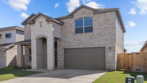 Exterior of two-story family home with modern brick exterior and front garage