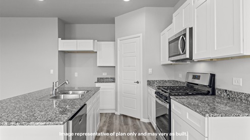 Open concept kitchen with stainless steel appliances, shaker style cabinets, and elevated finishes