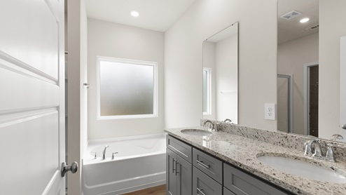 Bright and airy walk in shower with soaking tub inside the primary bathroom