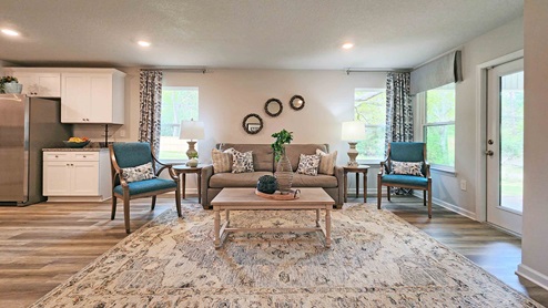 Living area with windows and access to patio door to covered porch.