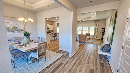 Dining room and foyer open to living area.