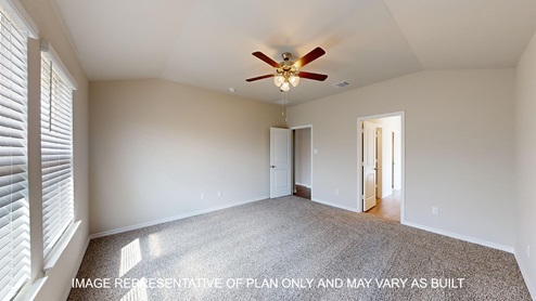 Monroe primary bedroom with carpet flooring and ceiling fan.