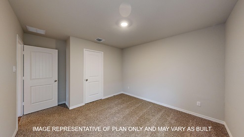 Monroe secondary bedroom with carpet flooring and closet door.