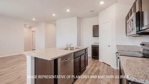 Schwertner Ranch model home primary closet with shelving and room for storage.