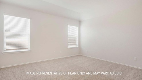 Schwertner Ranch model home secondary bedroom with carpet flooring and view of closet.