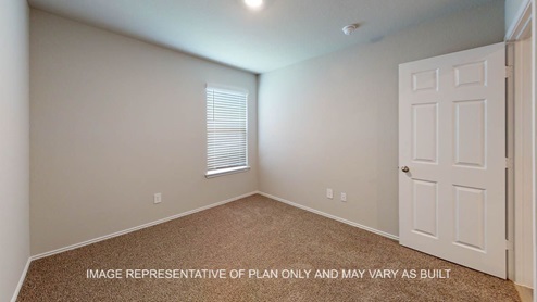 Camden secondary bedroom with carpet flooring.