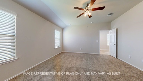 Seabrook primary bedroom with carpet flooring and windows.