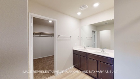 Texas Cali primary bath with dark cabinets and white countertops.