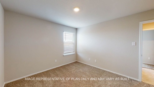 Texas Cali secondary bedroom with carpet flooring and windows.