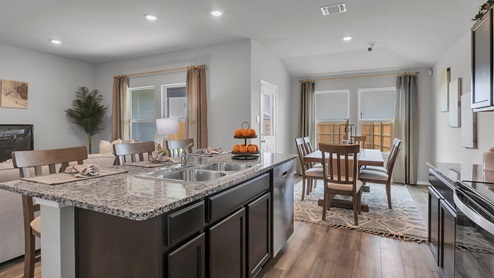 West Canyon Trails Model Home Kitchen with dark cabinets and granite countertops