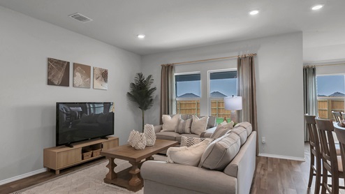 West Canyon Trails Model Home Living Room decorated with neutral furniture and windows