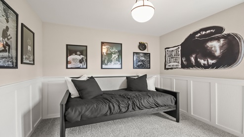 Secondary bedroom with windows, white walls, and light carpet.