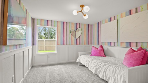Secondary bedroom with windows, white walls, and light carpet.