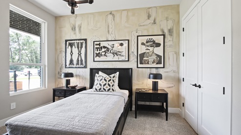 Secondary bedroom with windows, white walls, and light carpet.