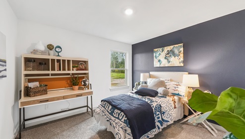Holly Trails model home secondary bedroom with a twin bed and carpet flooring.